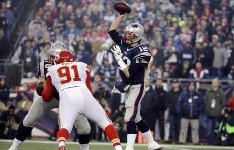 New England Patriots quarterback Tom Brady passef over the rush by Kansas City Chiefs outside linebacker Tamba Hali (91) in the first half.
